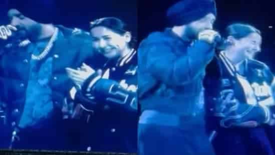 Diljit Dosanjh and Pakistani actor Hania Aamir on stage during his London concert.