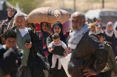Displaced Palestinians, who flee from Rafah amidst ongoing Israeli military operations following Israel's renewed offensive in the Gaza Strip, arrive in Khan Younis, Gaza, on Sunday, March 23, 2025. (AP Photo/Abdel Kareem Hana)