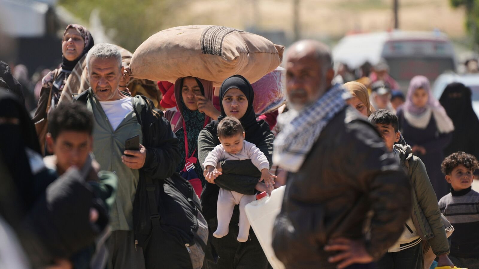 Displaced Palestinians, who flee from Rafah amidst ongoing Israeli military operations following Israel's renewed offensive in the Gaza Strip, arrive in Khan Younis, Gaza, on Sunday, March 23, 2025. (AP Photo/Abdel Kareem Hana)