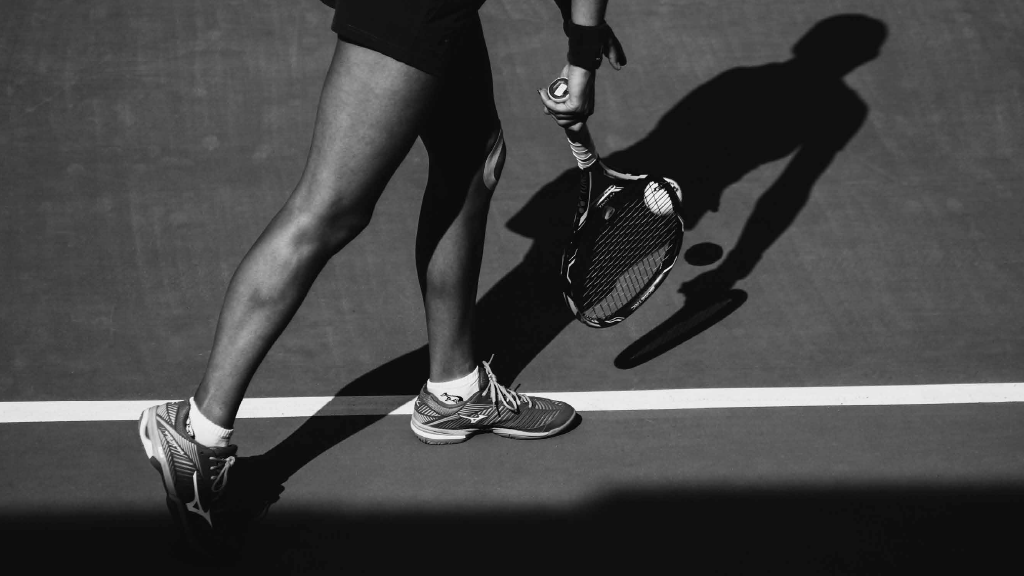 Best Hotels in Tampa Florida: Luxury Suites & Family-Friendly Stays at Saddlebrook Resort 11 Close-up of a tennis player preparing to serve on a professional court, symbolizing world-class amenities at Saddlebrook Resort.