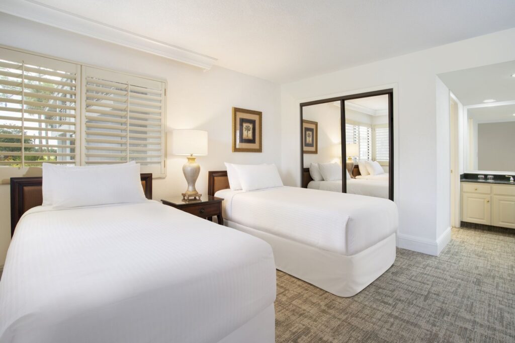 Best Hotels in Tampa Florida: Luxury Suites & Family-Friendly Stays at Saddlebrook Resort 16 Two-Bedroom Suites at Saddlebrook Resort featuring twin beds, warm lighting, and a spacious layout offering comfort and privacy for families.