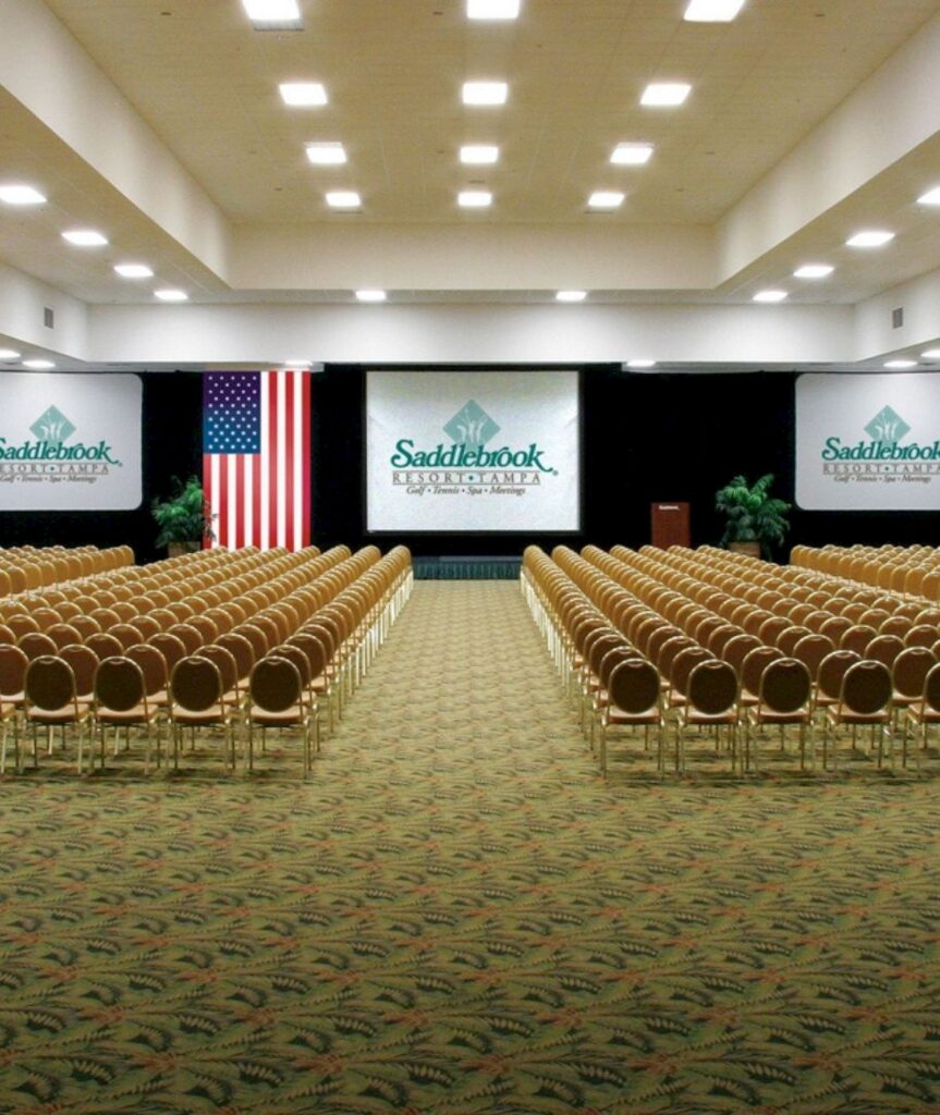 Best Hotels in Tampa Florida: Luxury Suites & Family-Friendly Stays at Saddlebrook Resort 24 Spacious conference hall at Saddlebrook Resort, set up for a large meeting or event with elegant seating and advanced audiovisual setup—inviting guests to plan their Saddlebrook experience today.