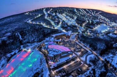 Experience the Thrill of Winter Sports at Blue Mountain Resort | Skiing & Snowboarding in Pennsylvania 2025 3 Aerial view of Blue Mountain Resort in the Pocono Mountains, Pennsylvania, glowing under twilight skies and showcasing ski trails, snow tubing areas, and illuminated slopes – Discover Pennsylvania's premier winter destination.