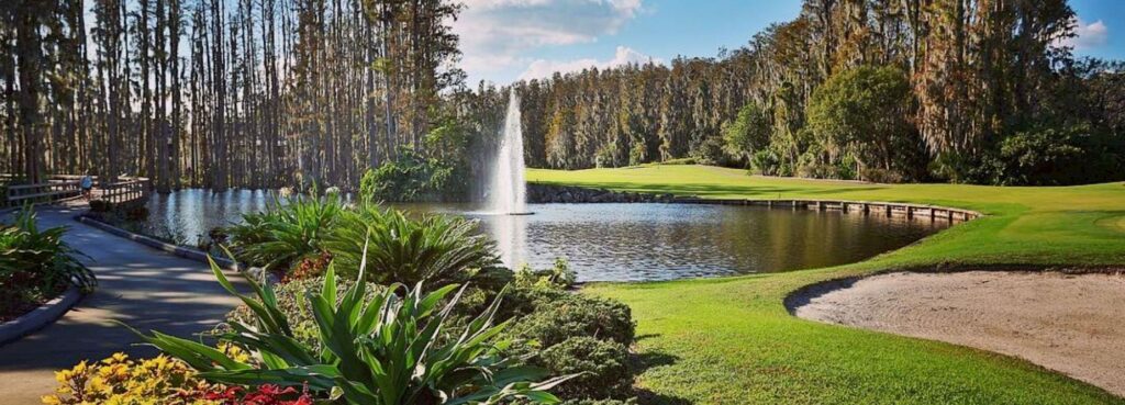 Best Hotels in Tampa Florida: Luxury Suites & Family-Friendly Stays at Saddlebrook Resort 19 Scenic golf course at Saddlebrook Resort featuring a sparkling fountain, lush greenery, and peaceful walking paths surrounded by tall trees in Tampa Bay’s hidden gem location.