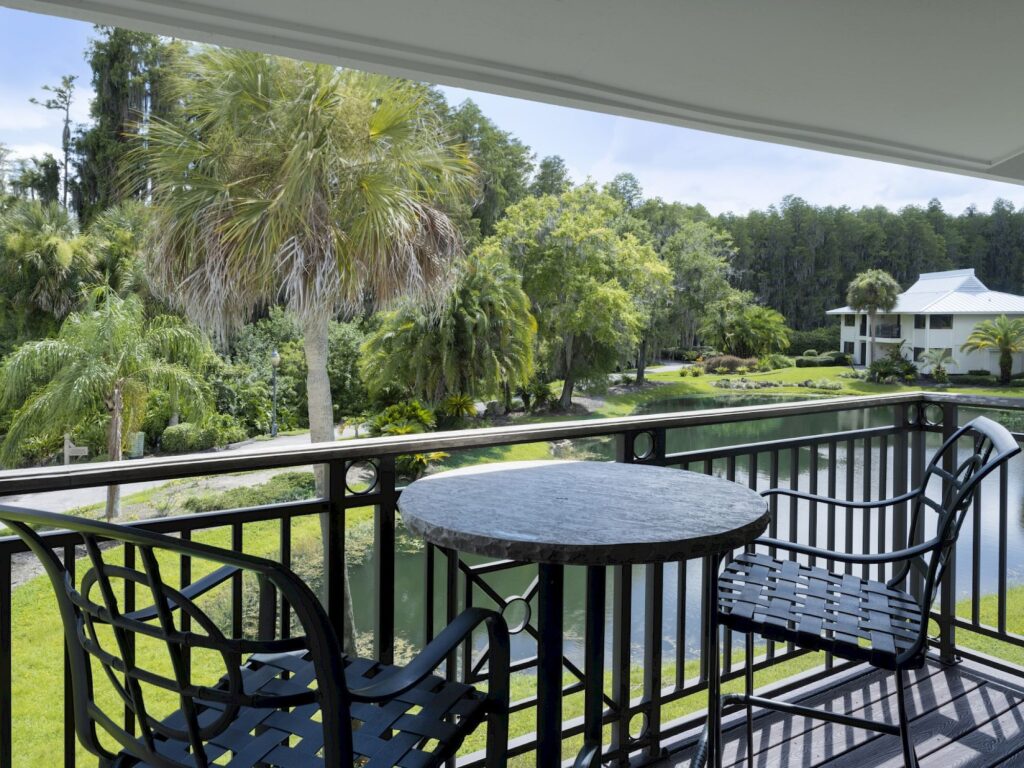 Best Hotels in Tampa Florida: Luxury Suites & Family-Friendly Stays at Saddlebrook Resort 20 Private balcony overlooking a serene pond and lush tropical greenery at Saddlebrook Resort, offering a peaceful retreat with modern comfort near urban Tampa.