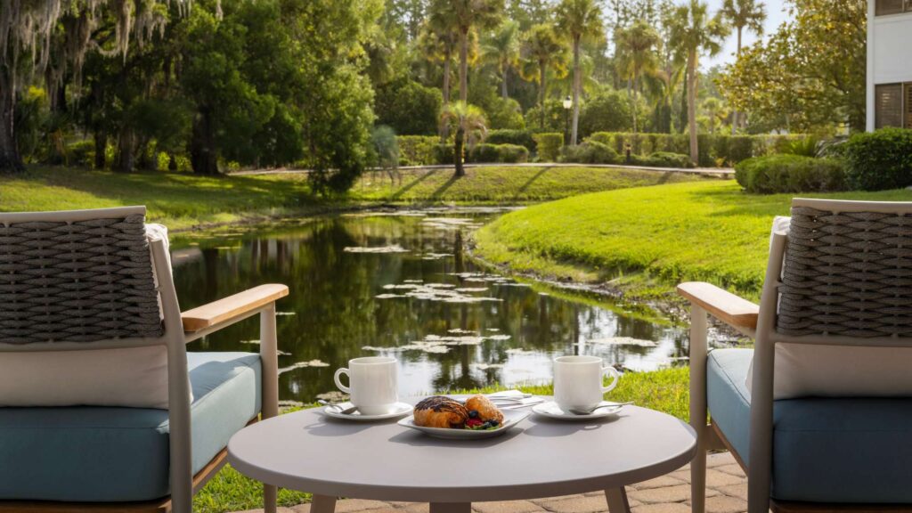Best Hotels in Tampa Florida: Luxury Suites & Family-Friendly Stays at Saddlebrook Resort 14 Private outdoor patio with coffee and pastries overlooking a serene pond — experience Resort Living with Residential Conveniences at Saddlebrook Resort.